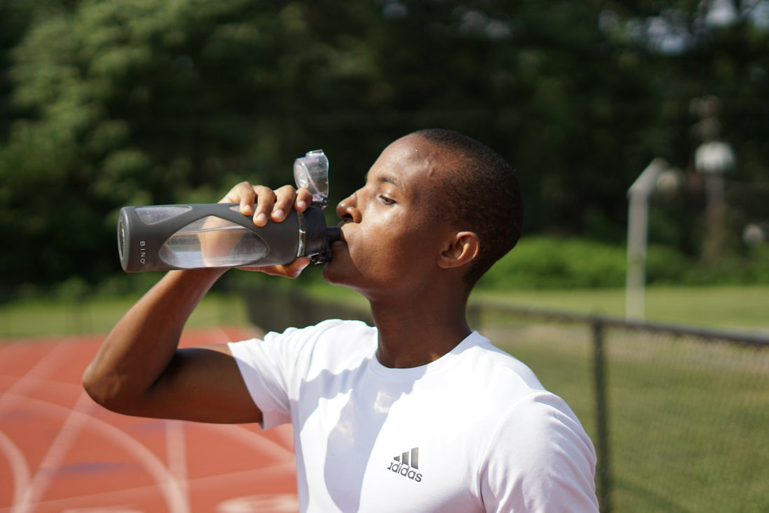 Man drinking water from a sports bottle for hydration and kidney health